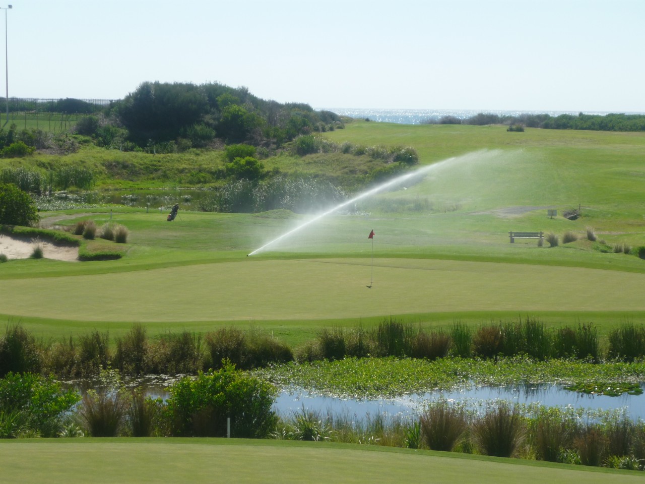 A sprinkler on a golf course