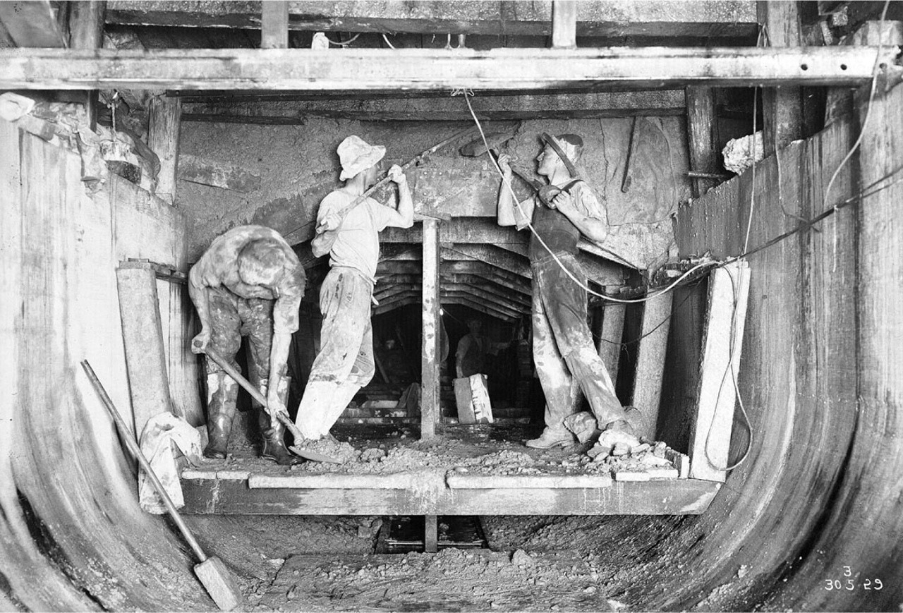 Woman standing by sink with coffee plunger