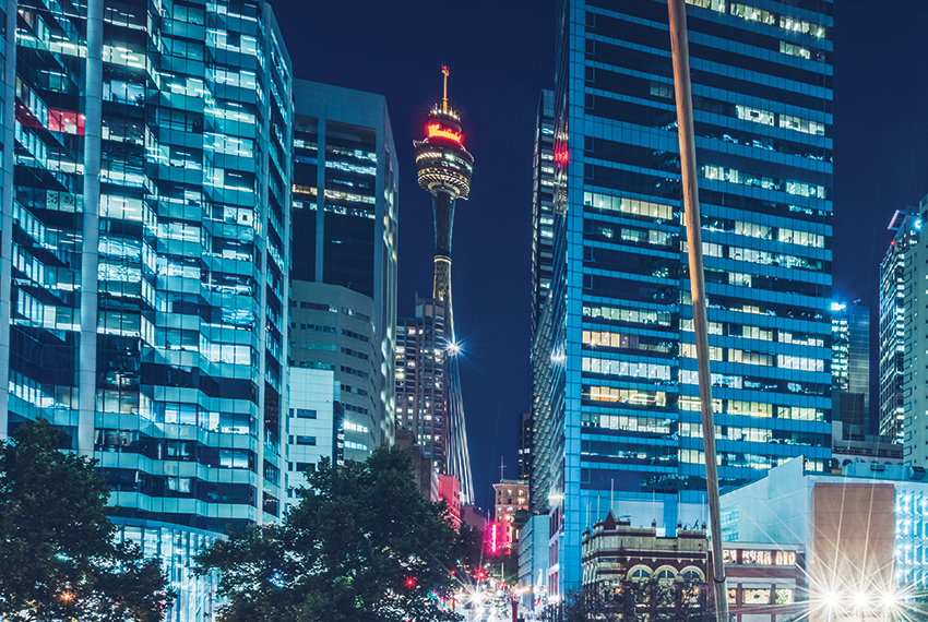 Lit commercial buildings in the Sydney CBD.