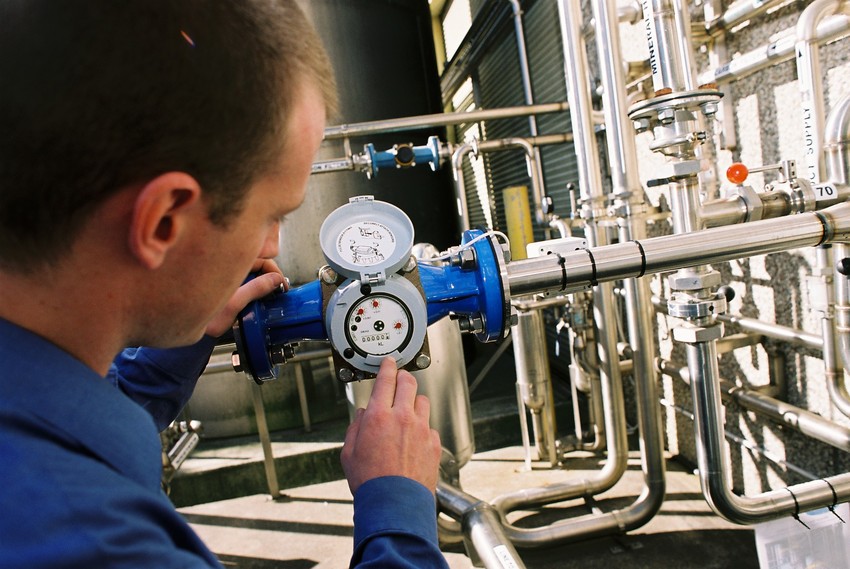 Plumber installing a data logger for online monitoring