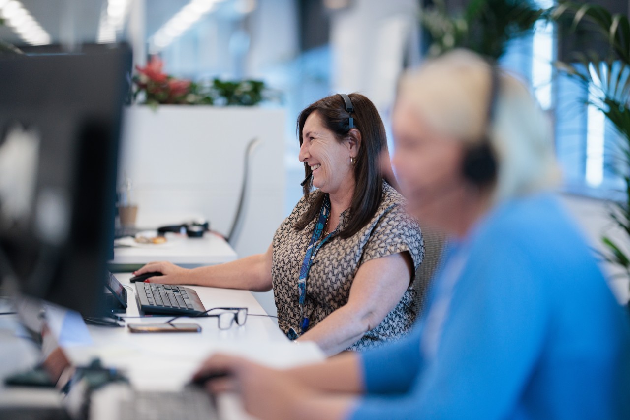 Two members of our customer support team taking calls from customers