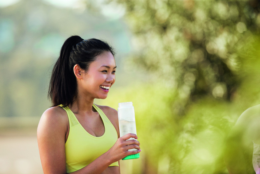 Girl drinking from refillable bottle