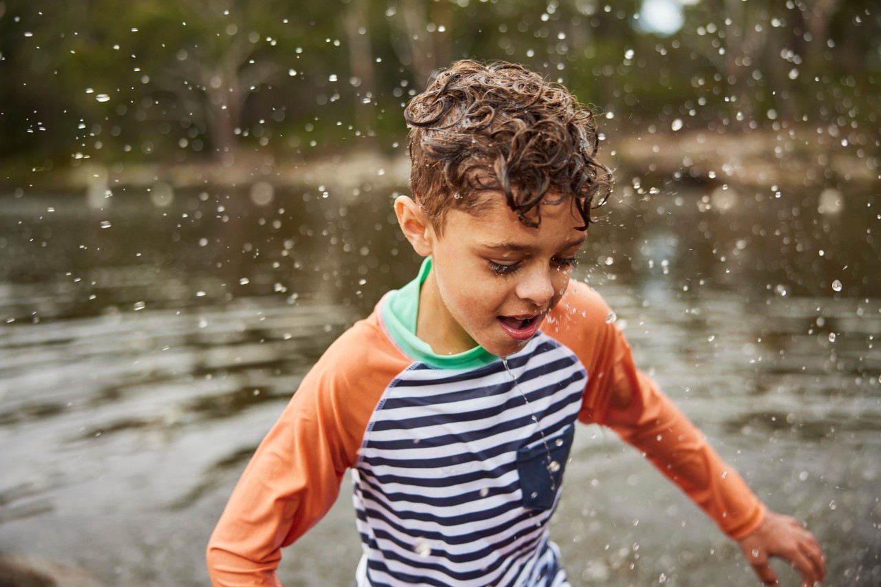 Indigenous boy splashing at Parramatta Lake