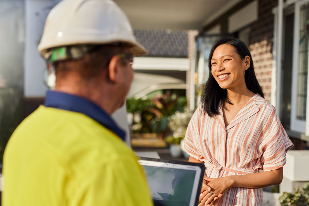 Customer smiling at Sydney Water employee