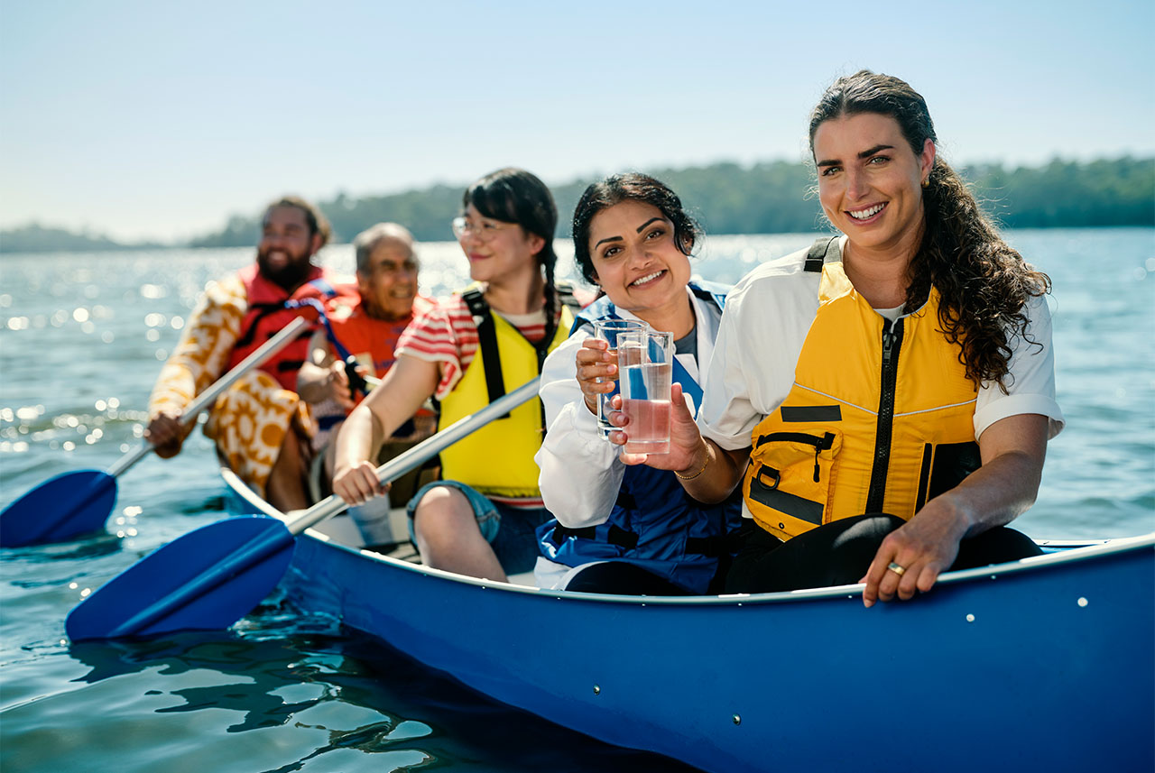 Jess fox and 4 people in a canoe on the water