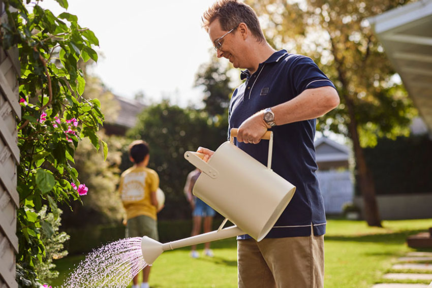 Family in backyard with watering can