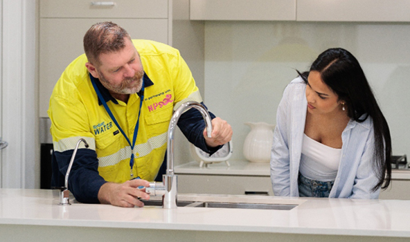  A plumber fixes a bathroom tap as part of our WaterFix Residential program.