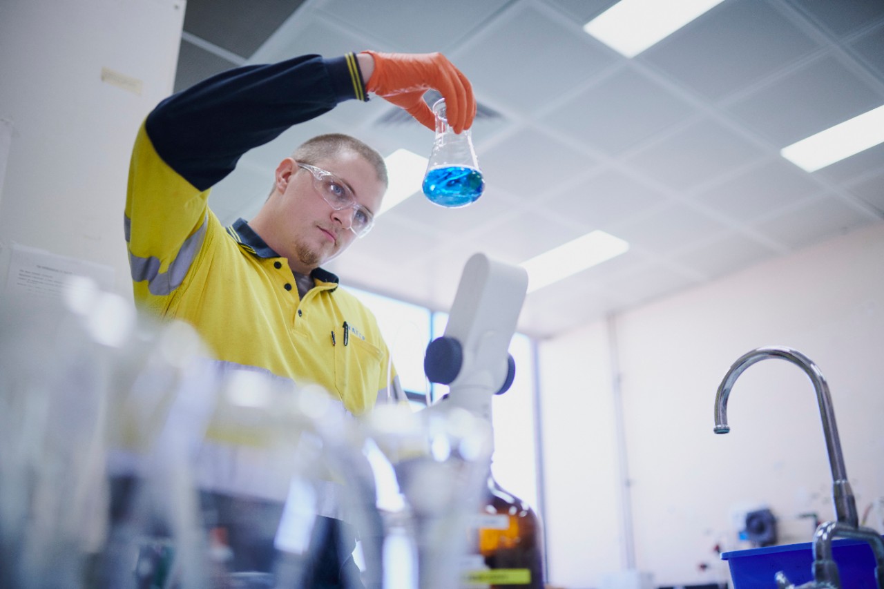 A photo of a man doing water quality tests.