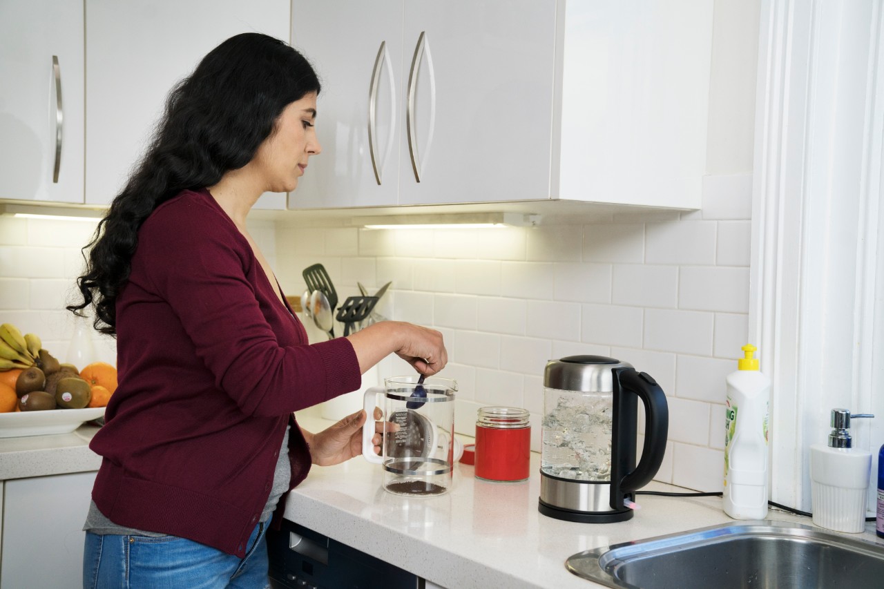 woman making a coffee in the kitchen