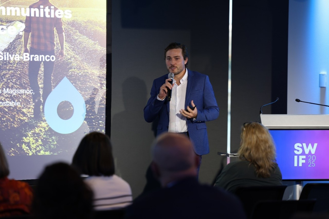 Male presenter in front of attendees at a SWIF25 Design Incubator Showcase