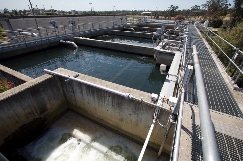 Water in large containers being treated. 