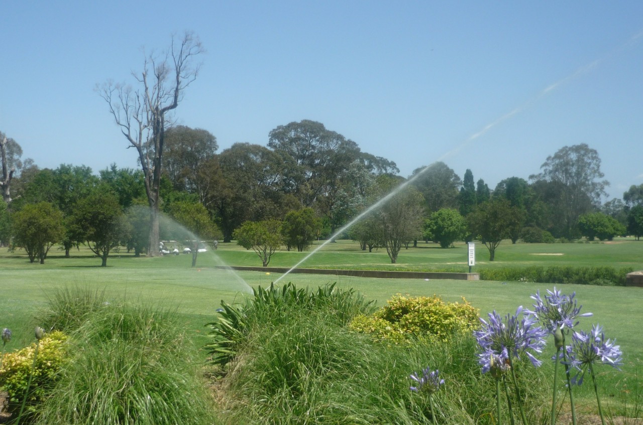 A sprinkler on a golf course