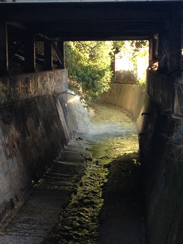 A stormwater drain with water in it.