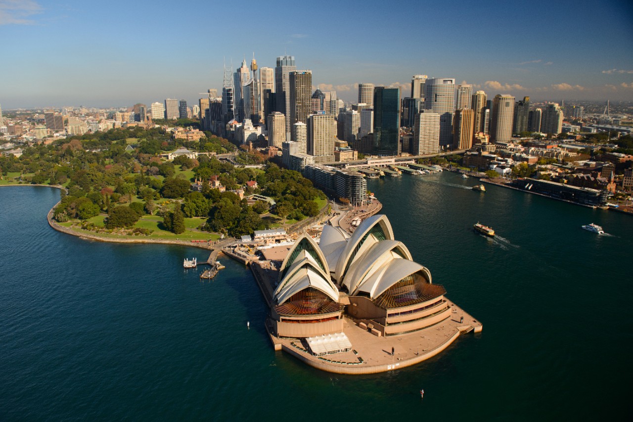 A photo of Sydney's Opera house, city and foreshore.