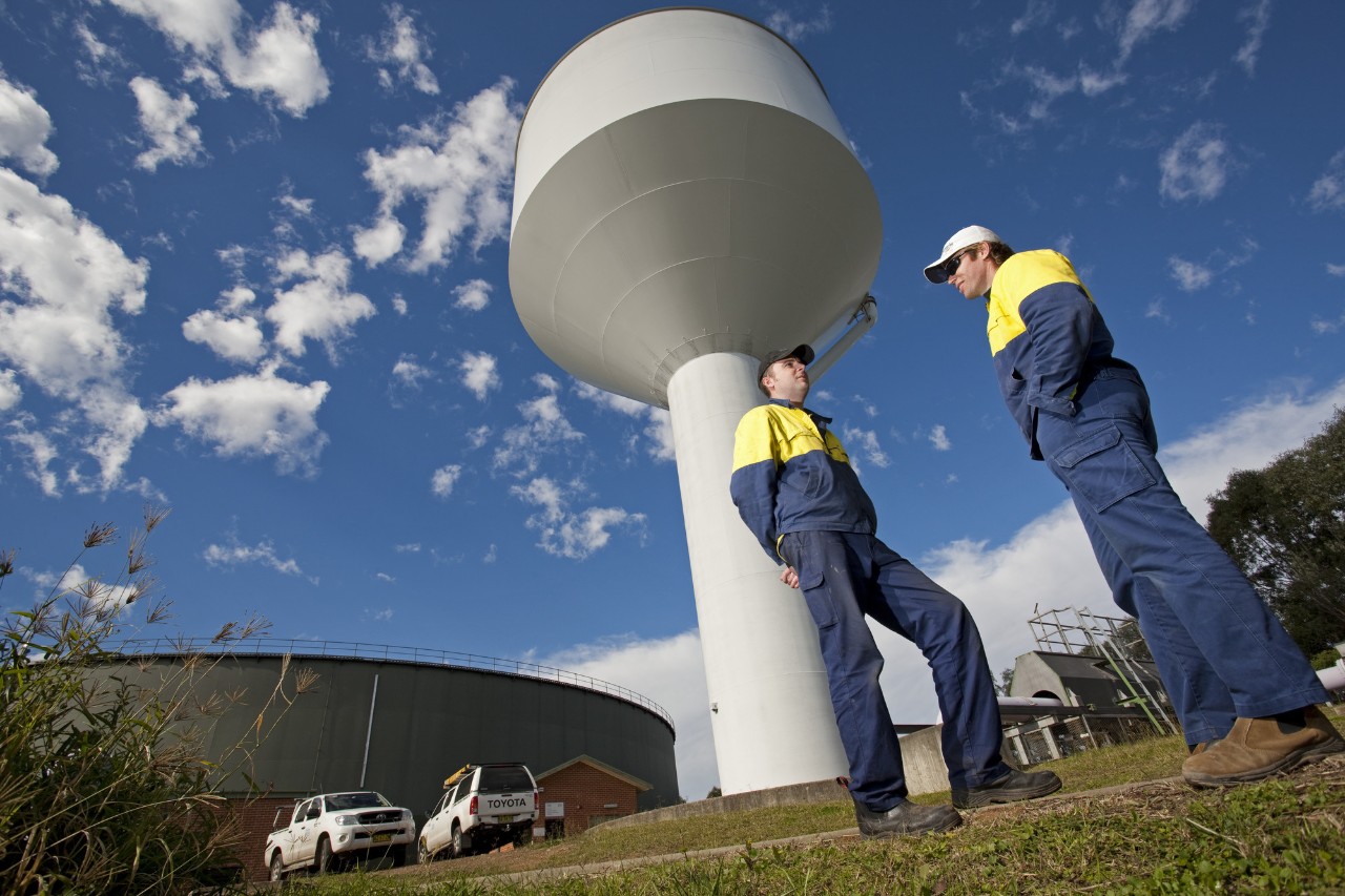 Sydney Water staff in front of recycled water reservoir