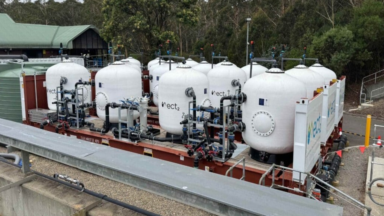 White filtration tanks at Cascade Water Filtration Plant connected by pipework and valves. 