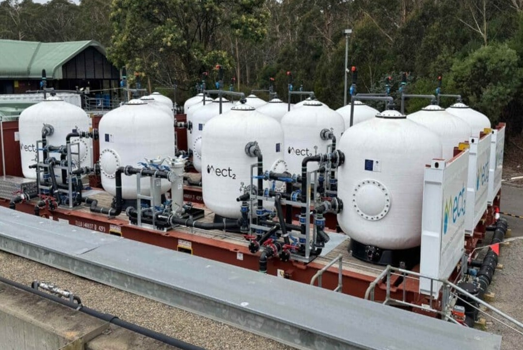 White filtration tanks at Cascade Water Filtration Plant connected by pipework and valves. 