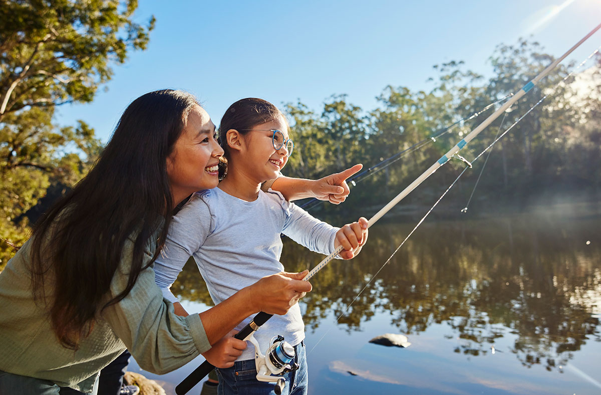 Woman and young girl fishing in a waterway