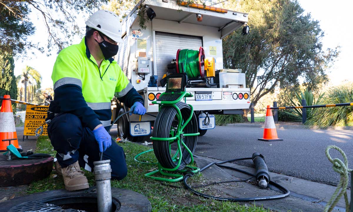 Sydney Water employee clearing a wastewater blockage with a high-pressure jetter