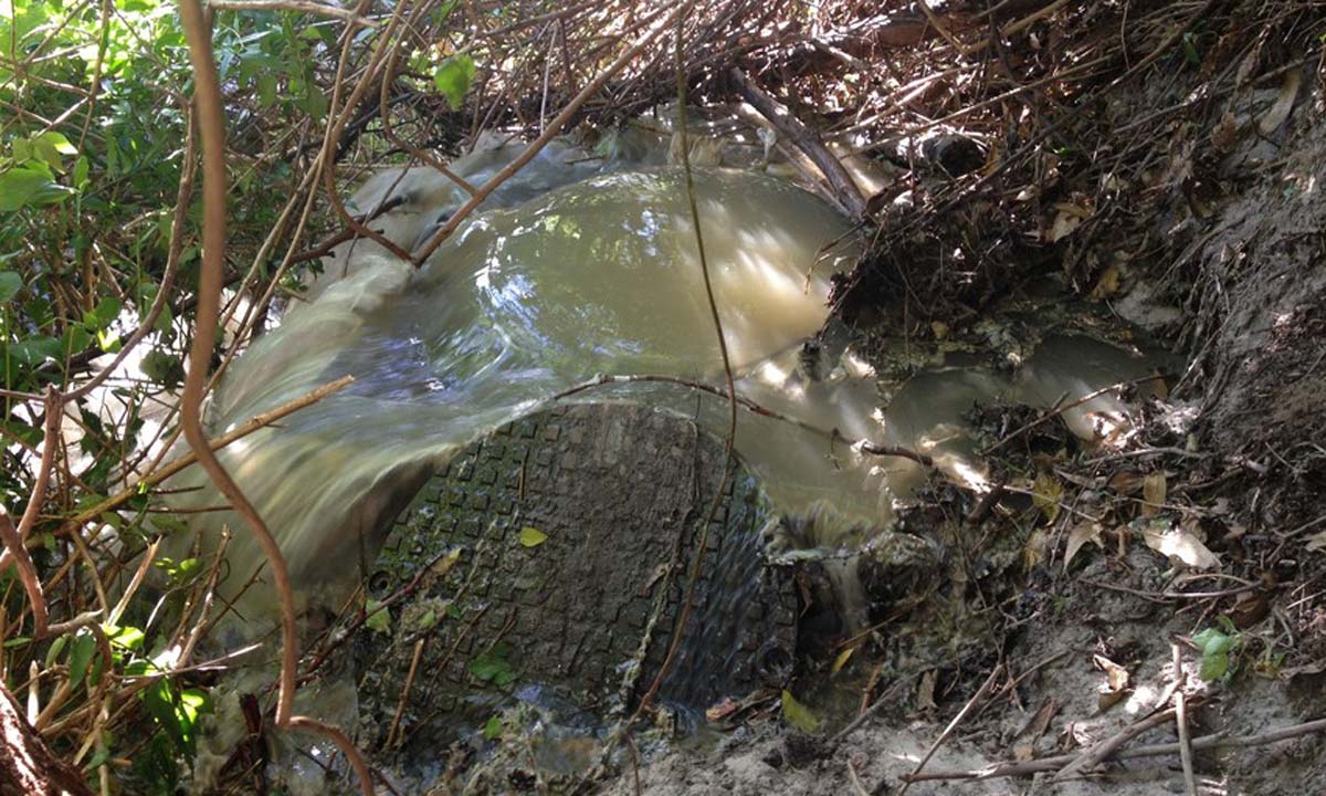 Maintenance hole overflow in bushland caused by heavy rain