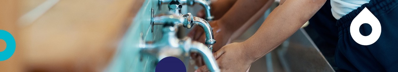 Primary age schoolgirls washing hands
