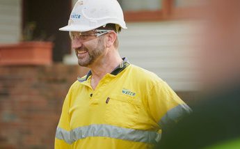 Sydney Water plumber standing at front of house