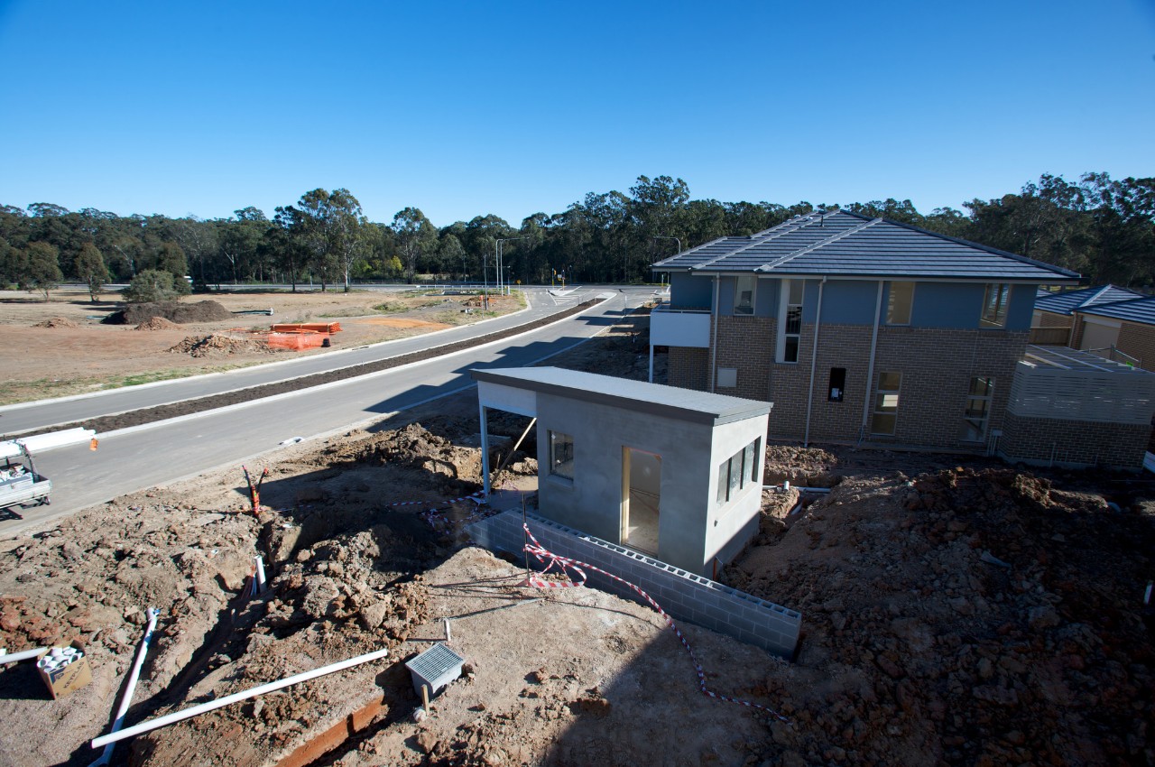 A street under development, with homes being built and ground dug up. This particular street will have recycled water available to them. 