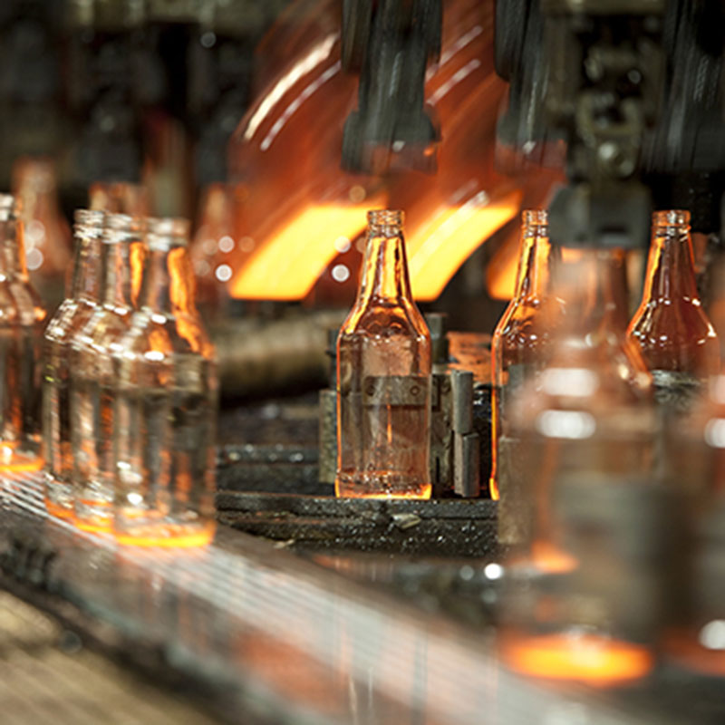 Glass bottles being produced on a production line. 